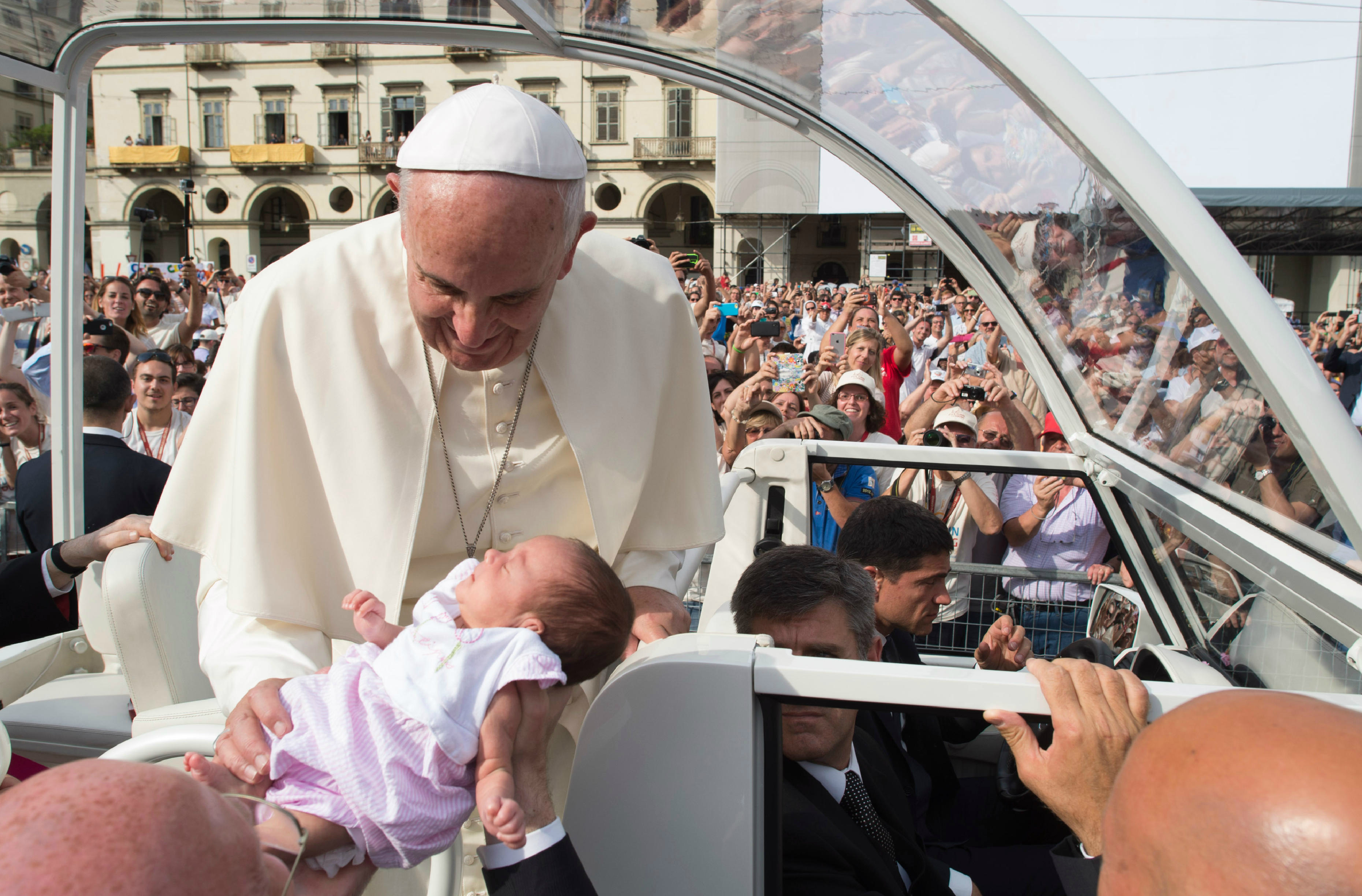 Pope Francis hugs a baby during his first day at Turin