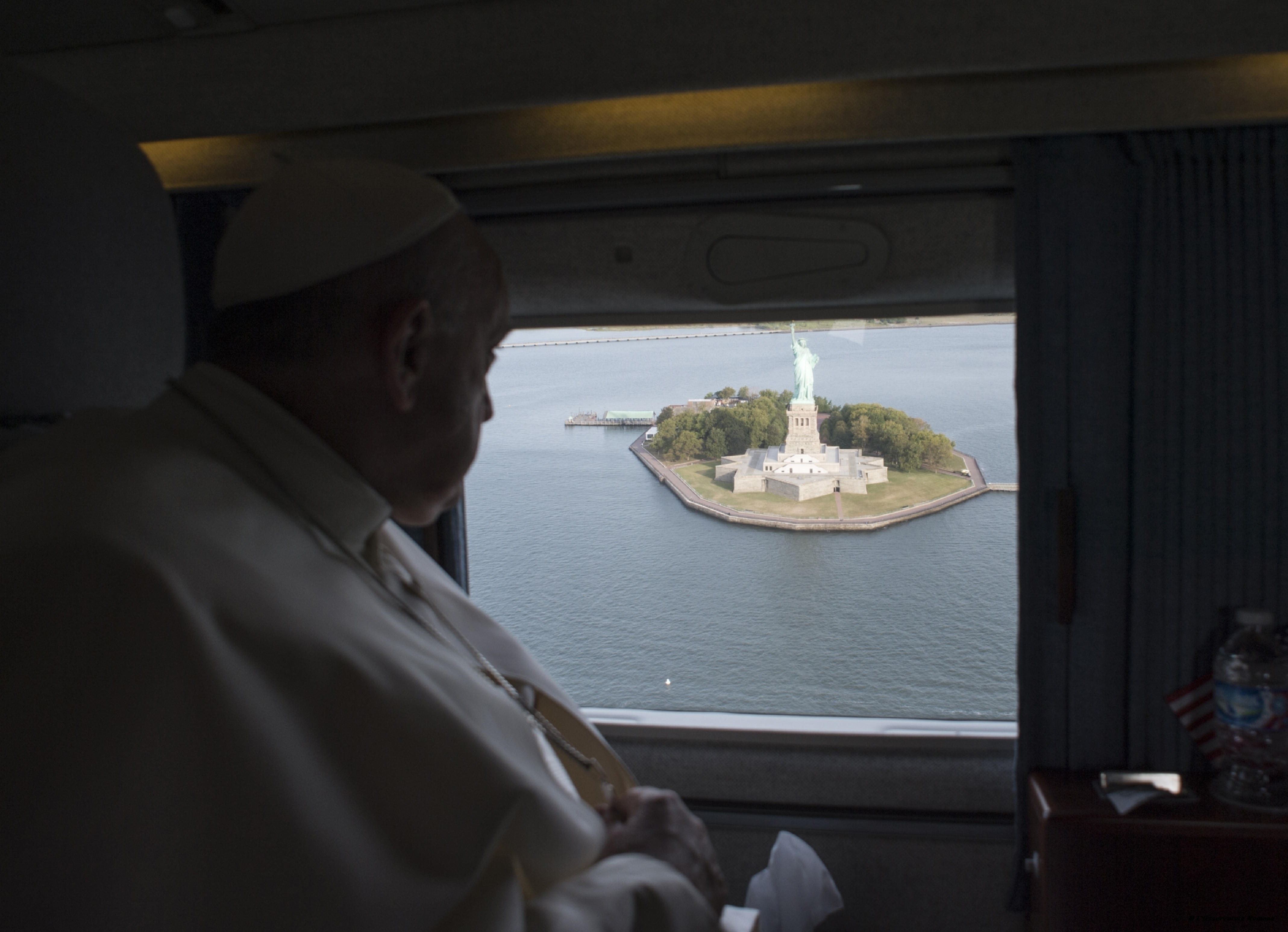 Pope Francis looks at the Statue of Liberty from the window of the helicopter on his way to the John F. Kennedy International Airport