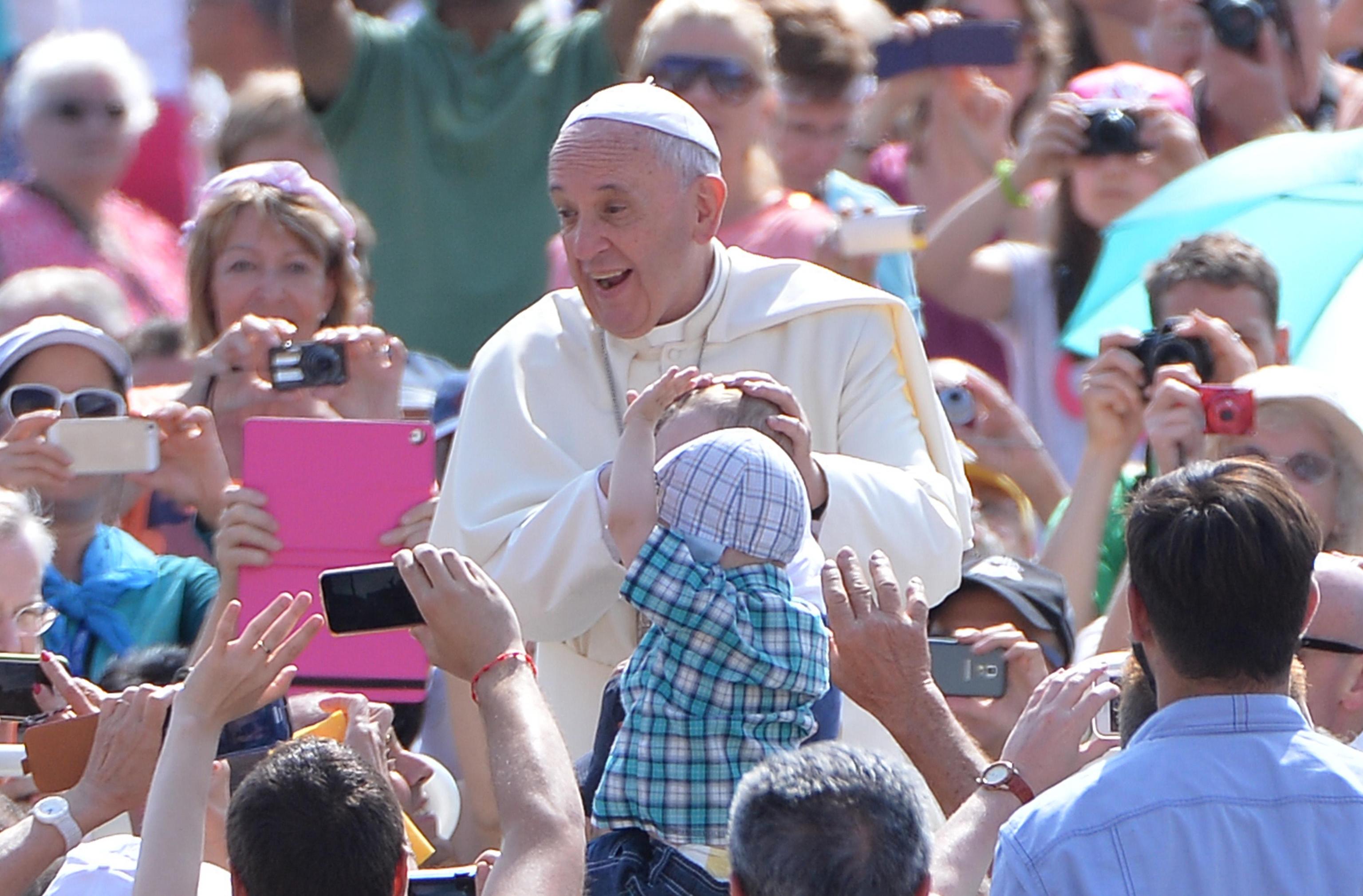Pope Francis greets the faithful at his weekly general audience in St. Peter's Square