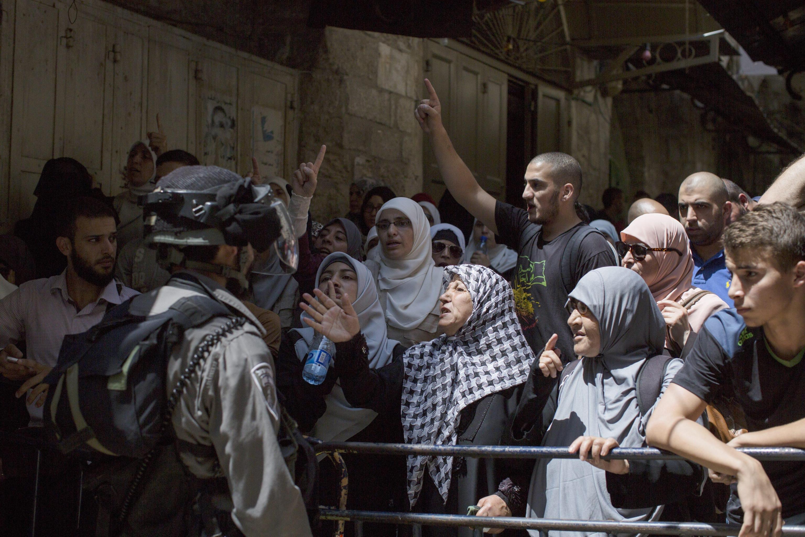 Israeli border police block Palestinians from entering into the Al-Aqsa mosque compound in the Old city of Jerusalem