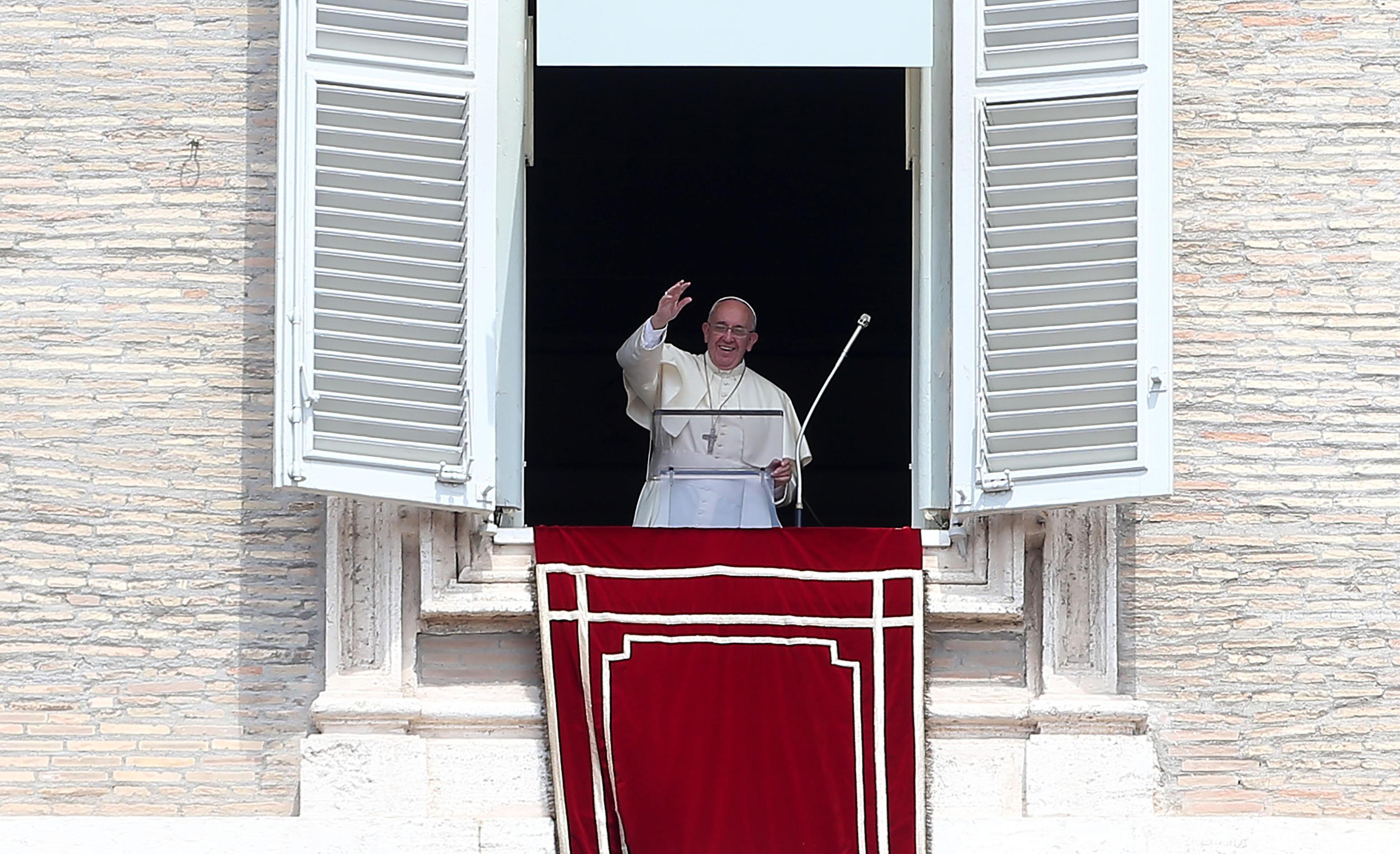 Pope Francis greets the faithful at the end of the prayer of the Angelus