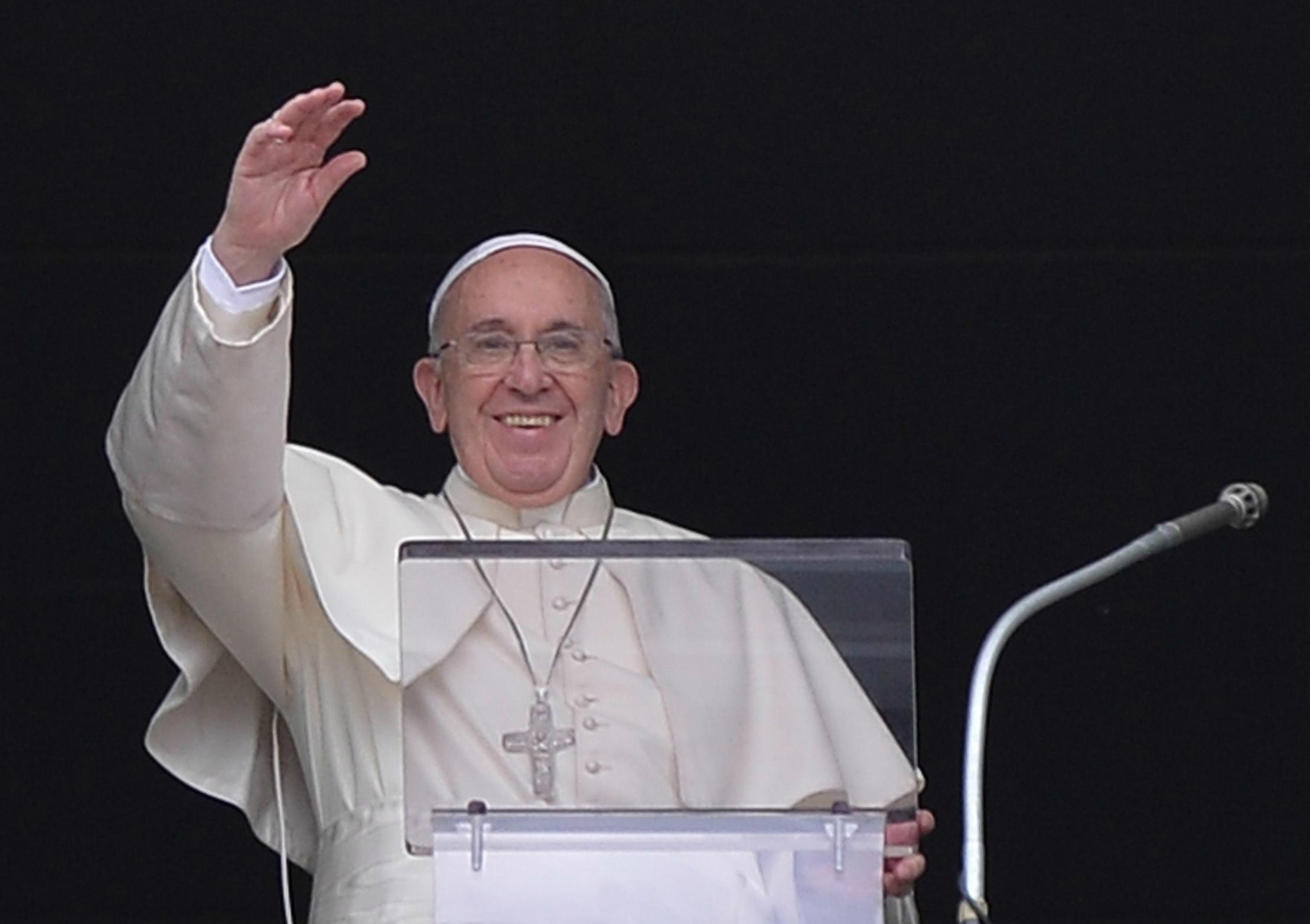 Pope Francis greets the faithful during the Angelus prayer in St. Peter's Square