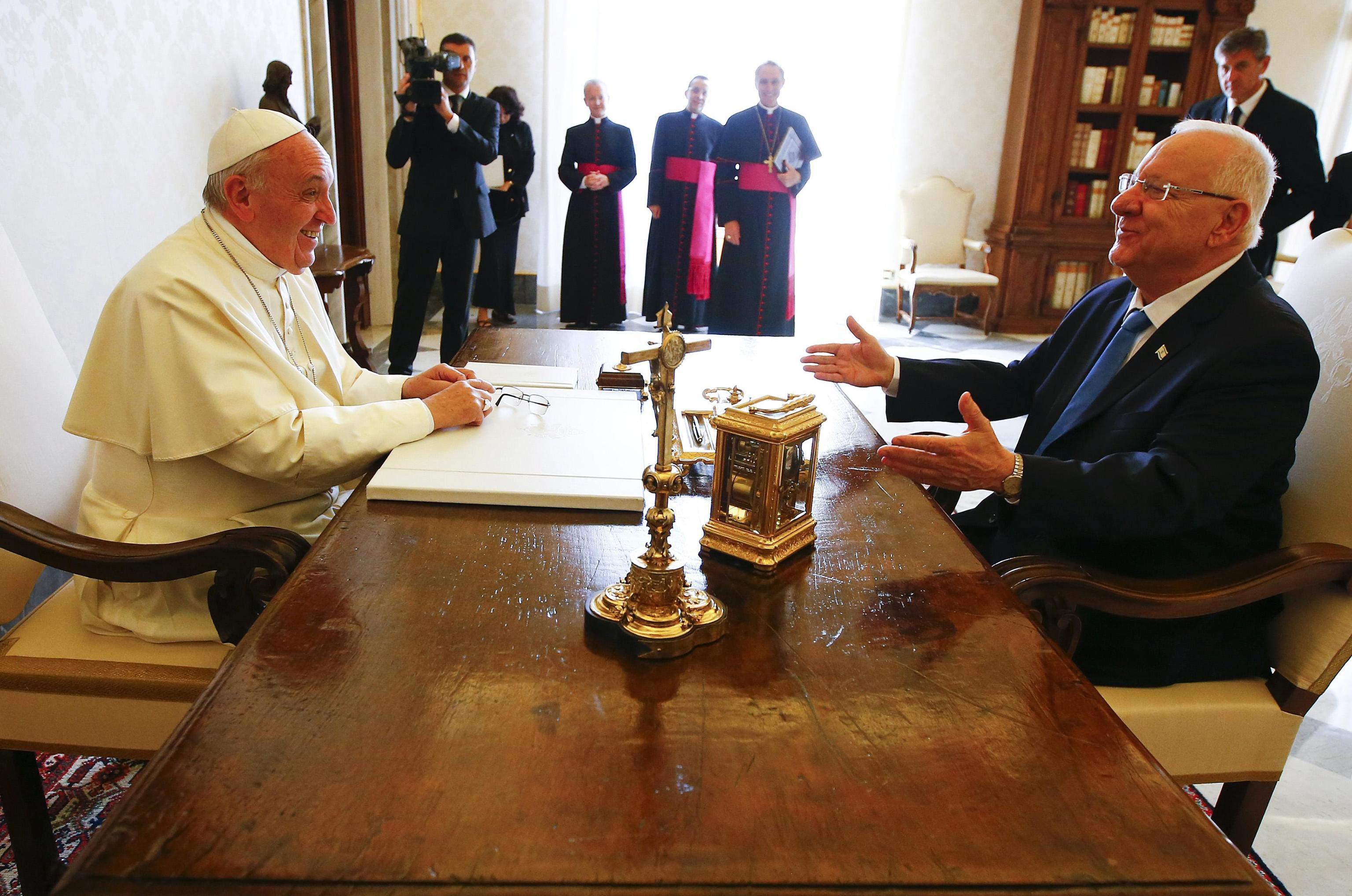 Pope Francis talks with Israel's President Reuven Rivlin during a private audience in Vatican