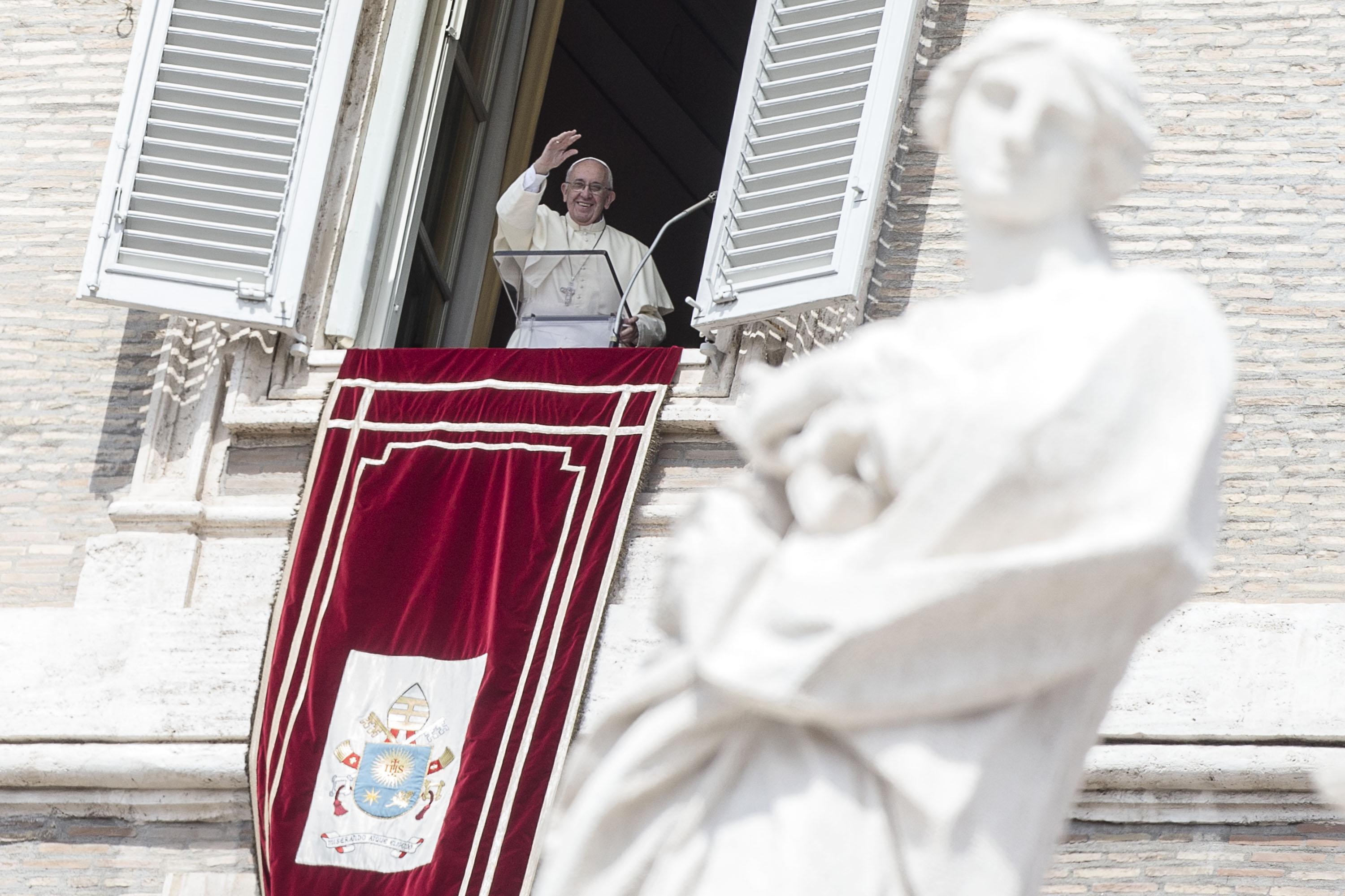 Pope Francis greets faithful during the Angelus prayer in St. Peter's Square