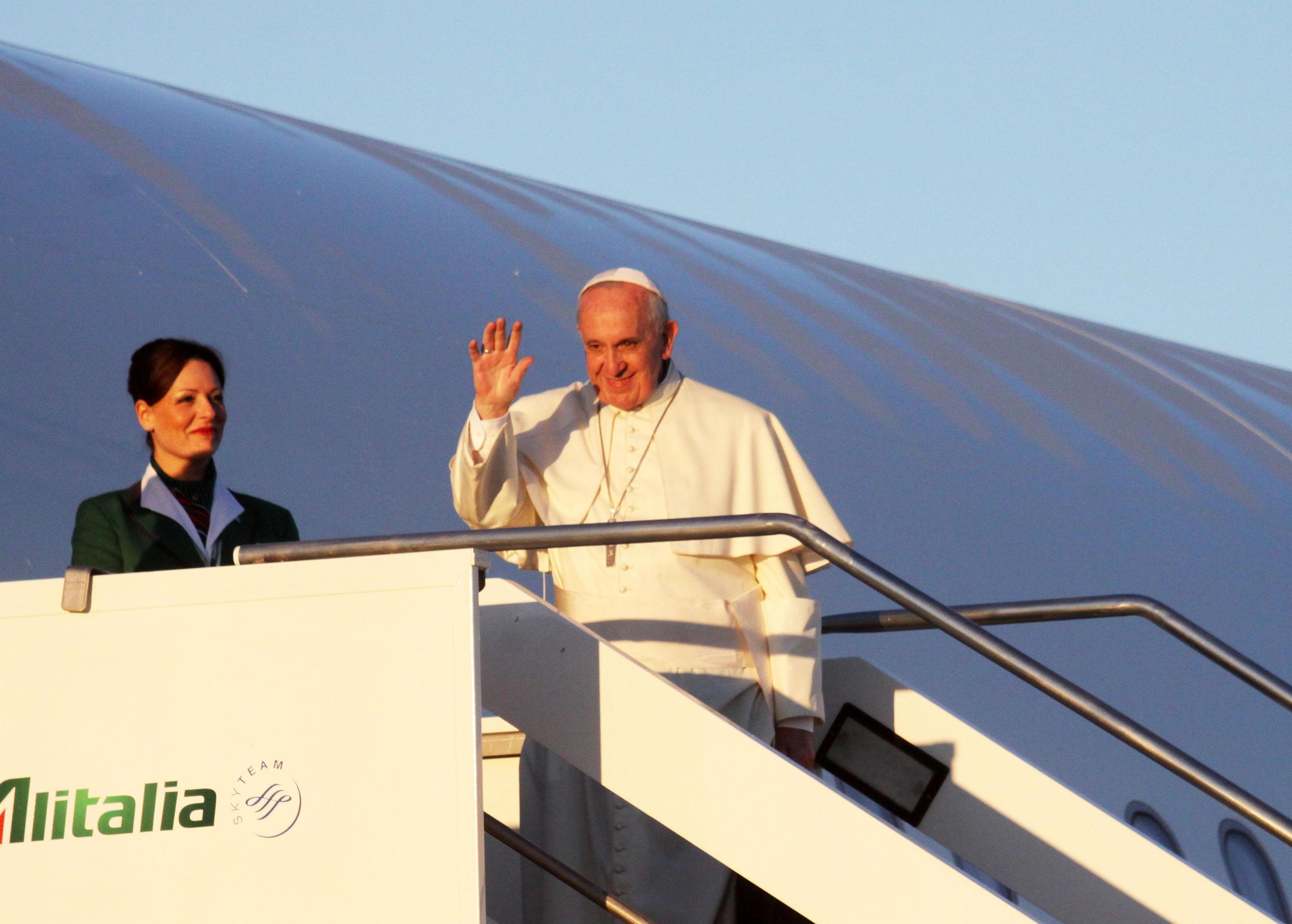 Pope Francis boards an Alitalia airplane at Rome's Fiumicino International Airport