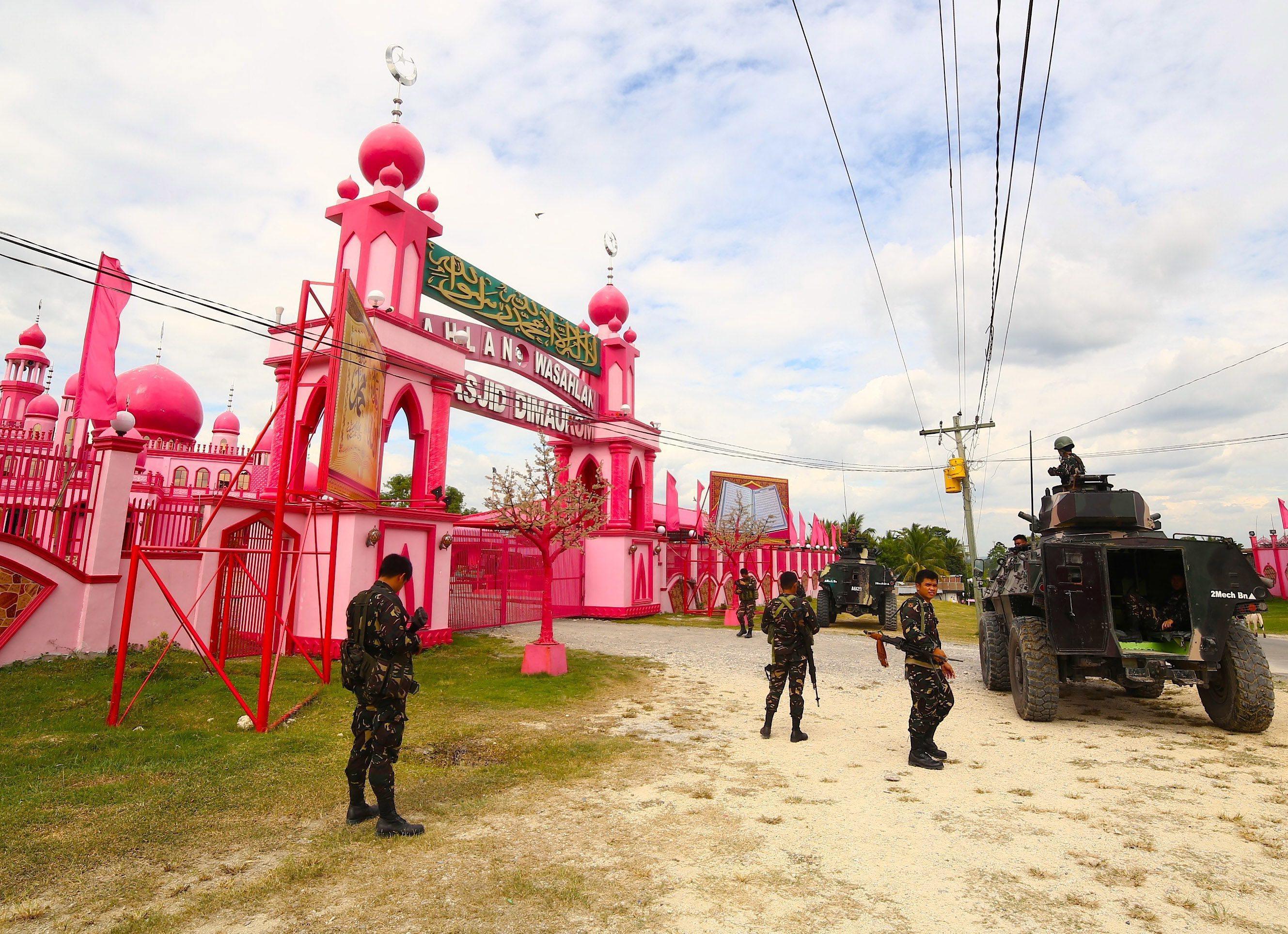 Filipino soldiers patrol in front of Pink Mosque in Datu Saudi Ampatuan