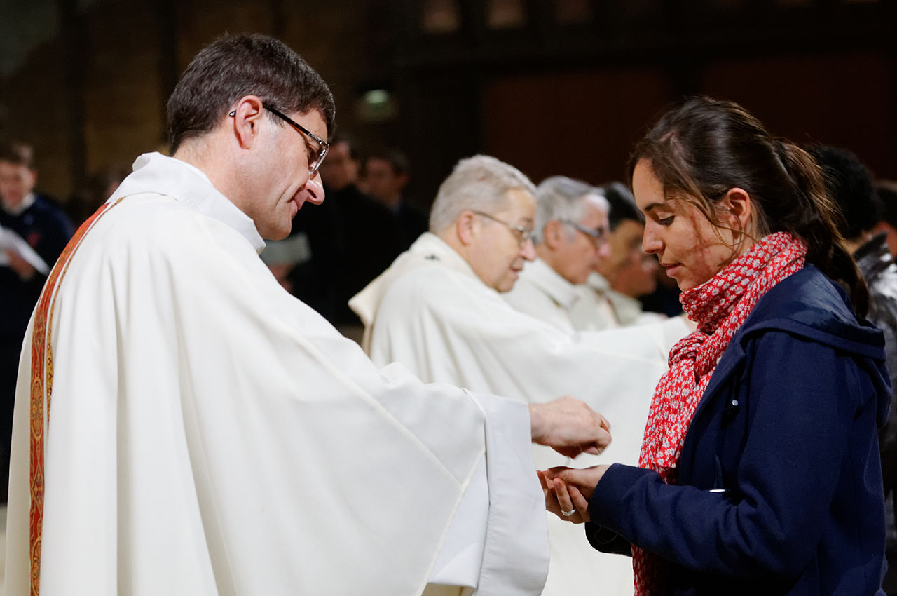 Holy Communion. Île-de-France students' mass in Cathedral Notre Dame de Paris celebrated by Mgr André Vingt-Trois